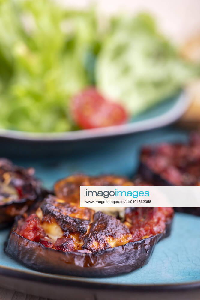 Grilled eggplants with cheese and salad 1035306816