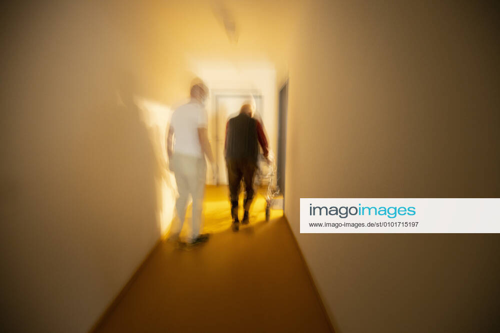Topic Nurse and man with walker in a dark hallway Heidelberg Germany