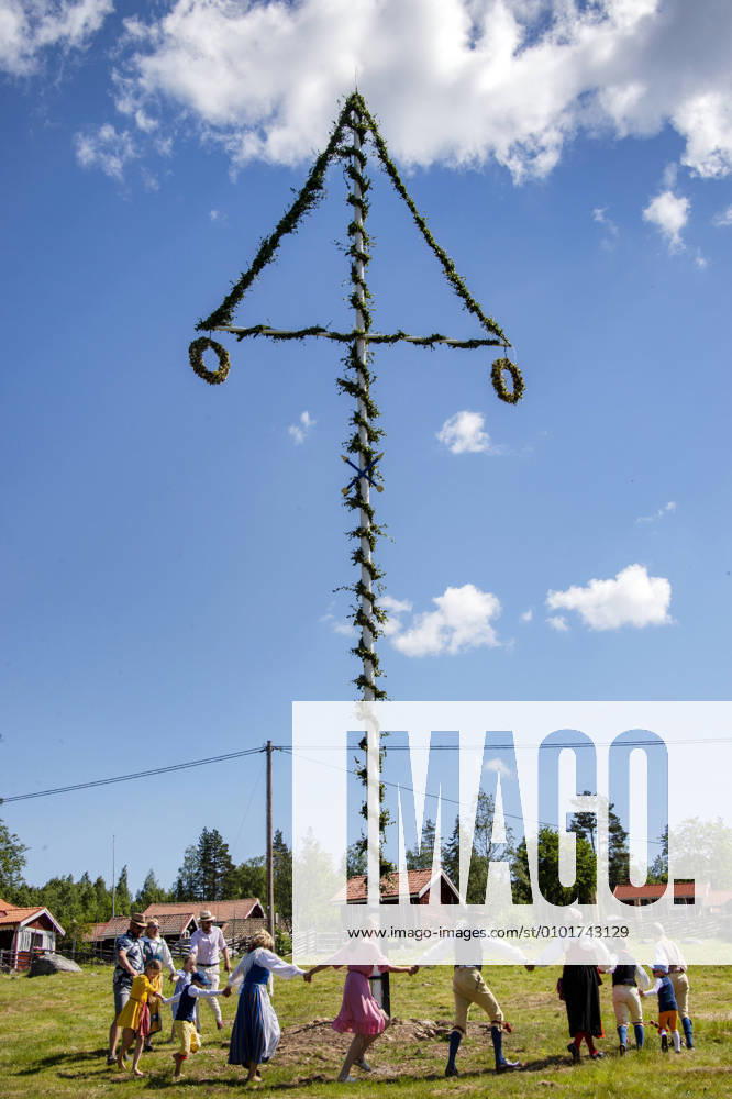 People dance around the maypole in Sahl, Sweden June 19, 2020. In the small village of Sahl in Dalarna midsummer is celebrated to a lesser extent and the elderly in the village stay at home or keep a distance due to the corona pandemic. Photo Ulf Palm TT Kod 9110 SÄHL Sweden