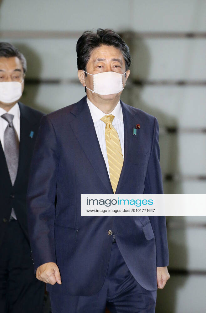Japan PM Abe Japanese Prime Minister Shinzo Abe enters his office in Tokyo on June 22, 2020, wearing a face mask amid continuing worries over the novel coronavirus.