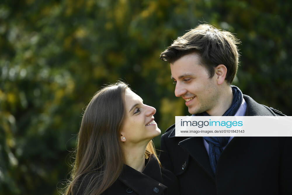 Young couple, smiling at each other, Karlsruhe, Baden Württemberg, Germany People