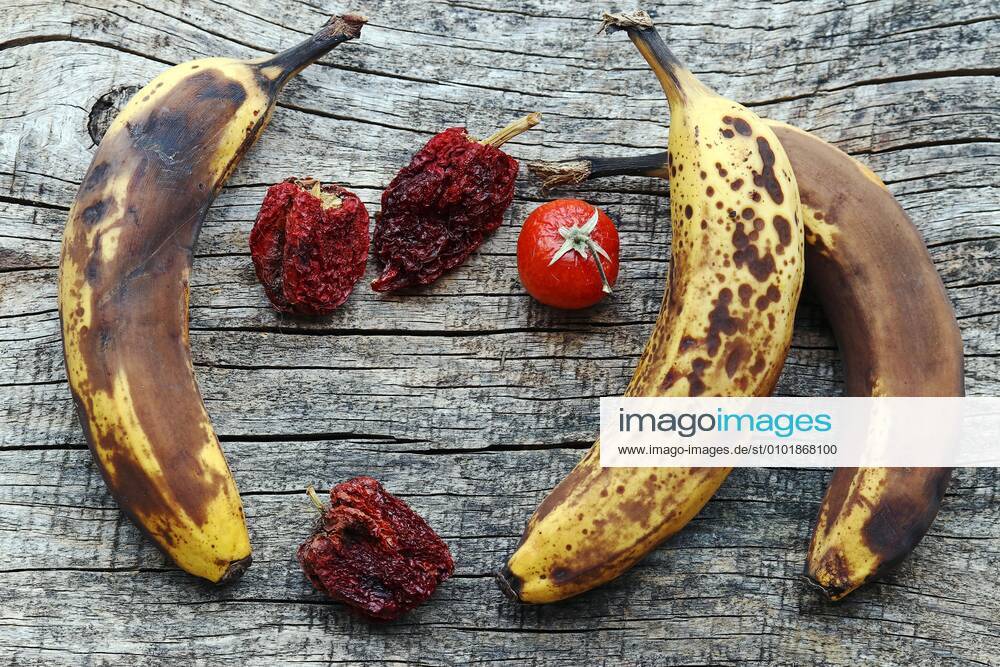Old brown bananas and dried peppers and tomatoes. Old fruit and vegetables