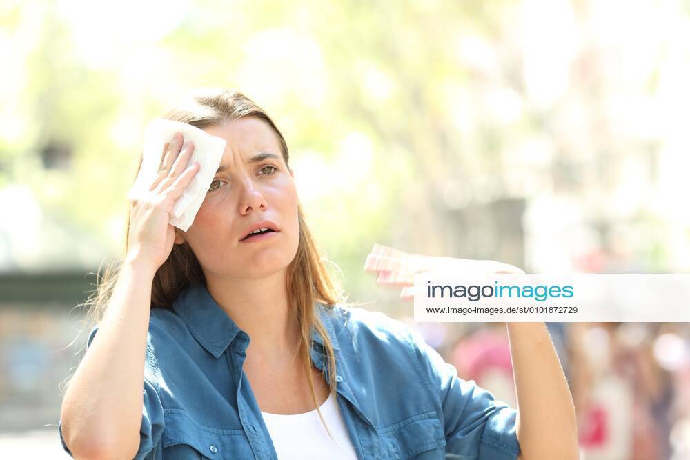 Unhappy woman sweating suffering a heat stroke