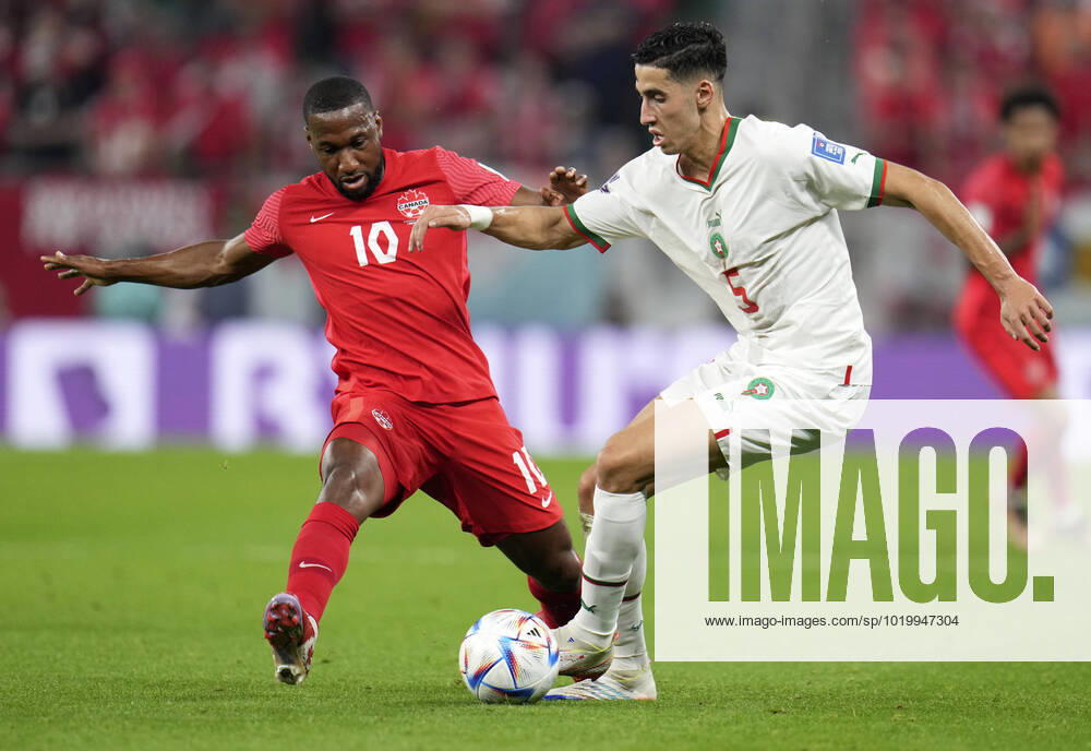 (221201) -- DOHA, Dec. 1, 2022 -- Junior Hoilett (L) of Canada vies with Nayef Aguerd of Morocco during their Group F match at the 2022 FIFA World Cup, WM, Weltmeisterschaft, Fussball at Al Thumama Stadium in Doha, Qatar, Dec. 1, 2022. ) (SP)QATAR-DOHA-2022 WORLD CUP-GROUP F-CAN VS MAR MengxDingbo