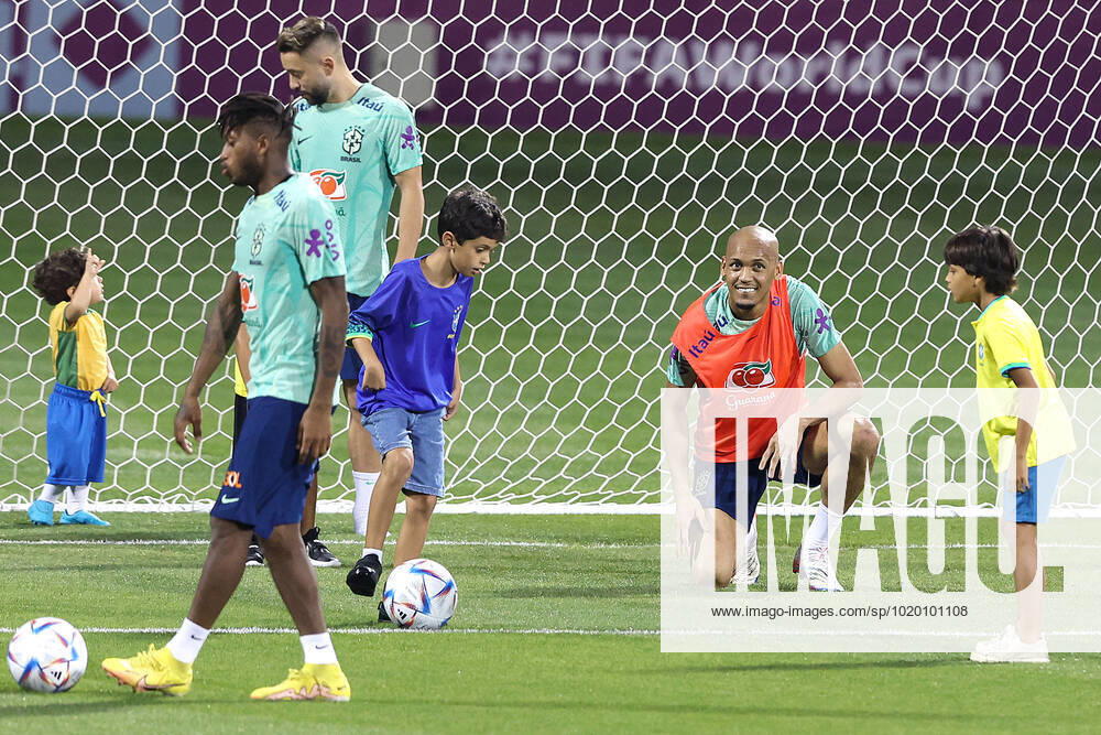 Brazil Training Session - FIFA World Cup, WM, Weltmeisterschaft, Fussball Qatar 2022 Fabinho of Brazil plays with children during Brazil training session at Al Arabi SC Stadium in Doha, Qatar on December 6, 2022. GoranxStanzl PIXSELL