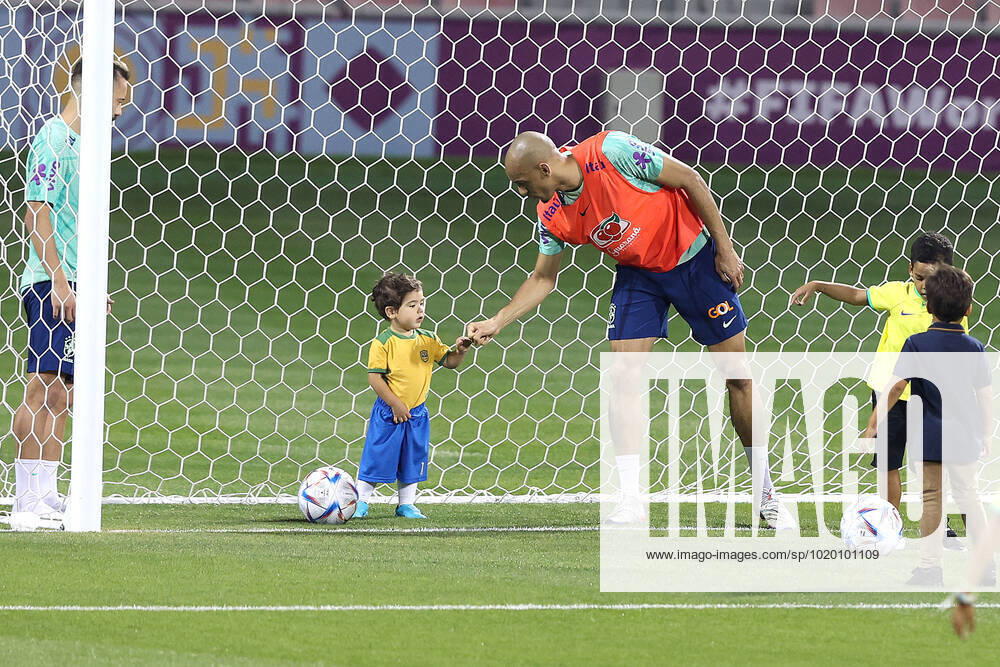 Brazil Training Session - FIFA World Cup, WM, Weltmeisterschaft, Fussball Qatar 2022 Fabinho of Brazil plays with children during Brazil training session at Al Arabi SC Stadium in Doha, Qatar on December 6, 2022. GoranxStanzl PIXSELL