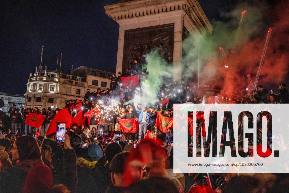 Morocco football supporters lit smoky flame and firework at Trafalgar Square to celebrate the winning over Portugal in 2022 FIFA World Cup, WM, Weltmeisterschaft, Fussball Moroccan, other North African and Middle-Eastern who reside in London celebrate in the city of London after Morocco beats Portugal in 2022 FIFA World Cup quarter-final. Morocco is the first African country breaking into semi-final in World Cup in history. London United Kingdom - ZUMAs197 20221210_zaa_s197_304