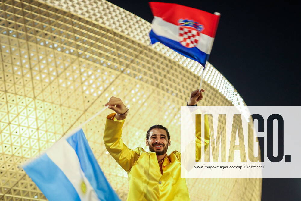 QATAR, LUSAIL - DECEMBER 13, 2022: A fan waves flags of Argentina and Croatia ahead of the 2022 FIFA World Cup, WM, Weltmeisterschaft, Fussball semifinal football match between Argentina and Croatia at Lusail Iconic Stadium. Sergei Bobylev TASS 56400331