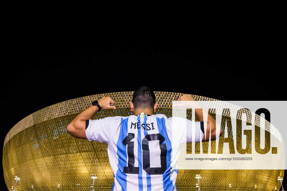 A man with a Lionel Messi jersey poses in front of Lusail Stadium ahead of the FIFA World Cup 2022 semifinal between Argentina and Croatia on December 13, 2022 in Doha Photo Joel Marklund BILDBYRAN code JM JM0411 bbeng football football soccer fotball vm fotbols vm fotball vm soccer world cup 2022 fifa world cup 2022 semi final semi final argentina croatia croatia arena exterior,