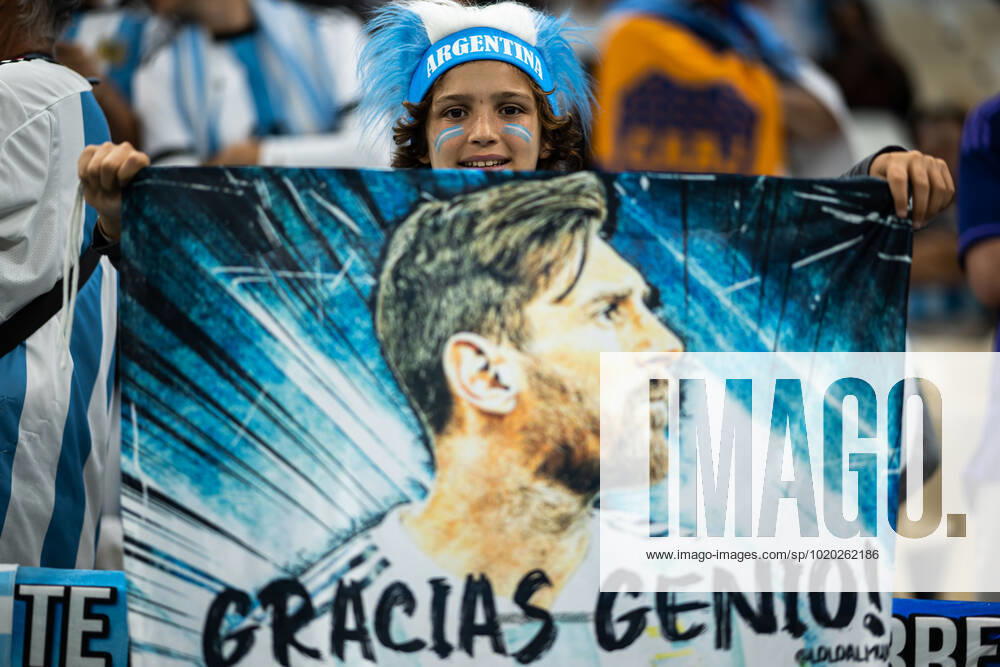 A young supporter of Argentina with a flag of Lionel Messi ahead of the FIFA World Cup 2022 semifinal between Argentina and Croatia on December 13, 2022 in Doha Photo Joel Marklund BILDBYRAN code JM JM0411 bbeng football football soccer fotball world cup football world cup football world cup 2022 fifa world cup 2022 semi final semi final argentina croatia croatia audience,