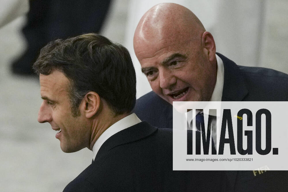 (221214) -- AL KHOR, Dec. 14, 2022 -- French President Emmanuel Macron (L) reacts with FIFA president Gianni Infantino prior to the Semifinal match between France and Morocco of the 2022 FIFA World Cup, WM, Weltmeisterschaft, Fussball at Al Bayt Stadium in Al Khor, Qatar, Dec. 14, 2022. ) (SP)QATAR-AL KHOR-2022 WORLD CUP-SEMIFINAL-FRA VS MAR DingxXu