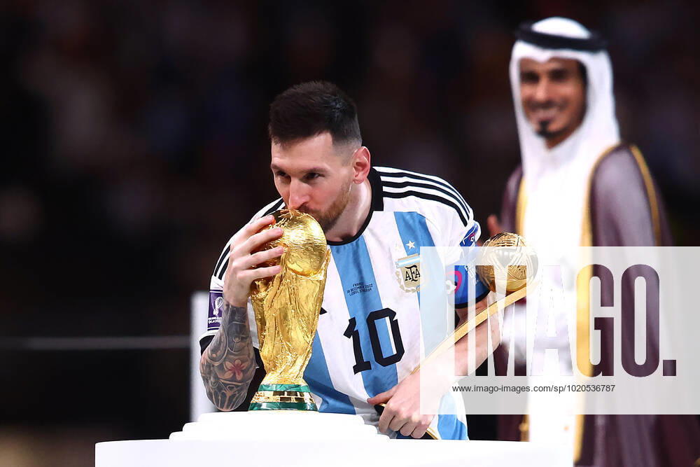Lionel Messi of Argentina kisses the FIFA World Cup, WM, Weltmeisterschaft, Fussball trophy following the 2022 FIFA World Cup Final at Lusail Stadium in Lusail City, Qatar on December 18, 2022. LUS20221218111 CHRISxBRUNSKILL