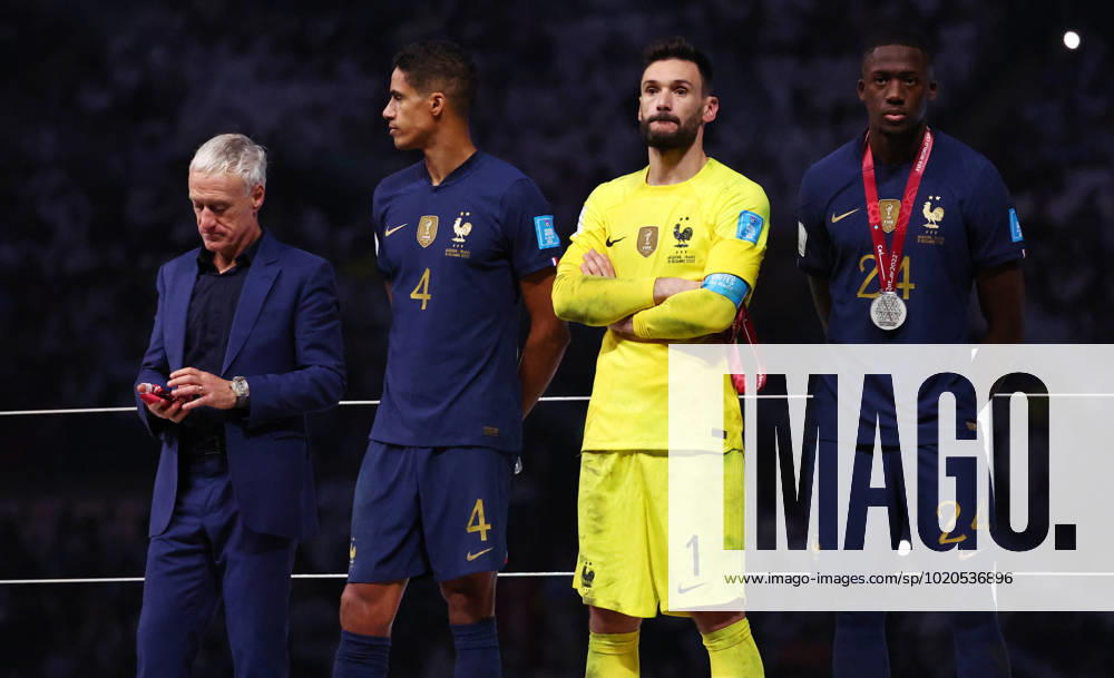 Doha, Qatar, 18th December 2022. Didier Deschamps coach of France looks at his loosers medal as Raphael Varane, Hugo Lloris and Ibrahima Konate of France stand around dejected during the FIFA World Cup, WM, Weltmeisterschaft, Fussball 2022 match at Lusail Stadium, Doha. Picture credit should read: David Klein Sportimage . SPI-2101-0233