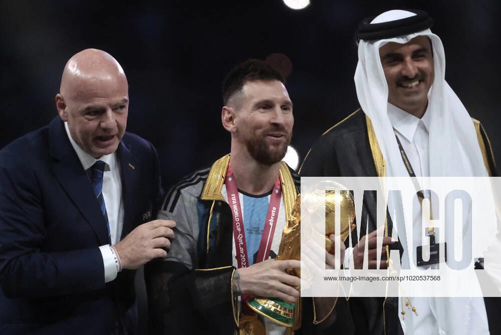 Lionel Messi (C) from Argentina poses with the World Cup trophy together with FIFA President Giovanni Vincenzo (L) and the Emir of the State of Qatar in the final of the FIFA World Cup, WM, Weltmeisterschaft, Fussball soccer tournament between Argentina and France at Lusail stadium in Lusail, Qatar, 18 December 2022. Soccer World Cup 2022: Argentina - France !ACHTUNG: NUR REDAKTIONELLE NUTZUNG!