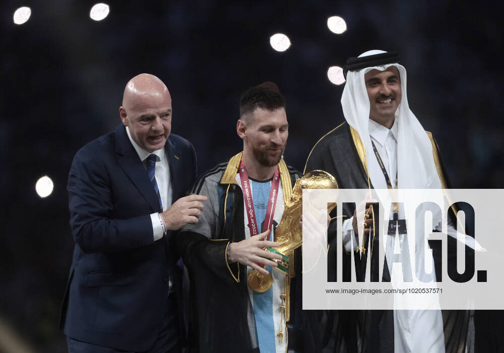 Lionel Messi (C) from Argentina poses with the World Cup trophy together with FIFA President Giovanni Vincenzo (L) and the Emir of the State of Qatar in the final of the FIFA World Cup, WM, Weltmeisterschaft, Fussball soccer tournament between Argentina and France at Lusail stadium in Lusail, Qatar, 18 December 2022. Soccer World Cup 2022: Argentina - France !ACHTUNG: NUR REDAKTIONELLE NUTZUNG!