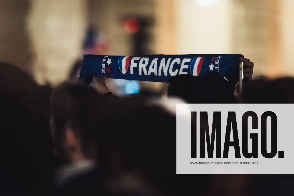 French Football Team Fans Greet The Players On The Place De La Concorde In Paris A French football team fan holds up a scarf with the word France over the crowd gathered on the Place de la Concorde to welcome the players on the balcony of the Crillon hotel after their return from Qatar after their defeat against Argentina in the World Cup final in Paris on December 19 2022. Paris France