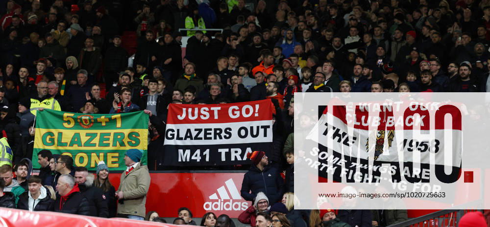 Manchester, England, 21st December 2022. Manchester Utd fans hold up banners prior to there fixture in the Carabao Cup Fourth Round match at Old Trafford, Manchester. Picture credit should read: Darren Staples Sportimage . SPI-2104-0006
