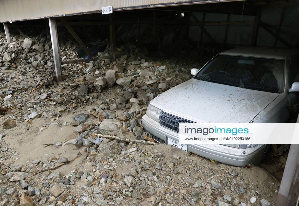 Torrential rain in central Japan Photo taken July 9, 2020, shows a car half-buried in mud in Gero in Gifu Prefecture, central Japan, after torrential rain.