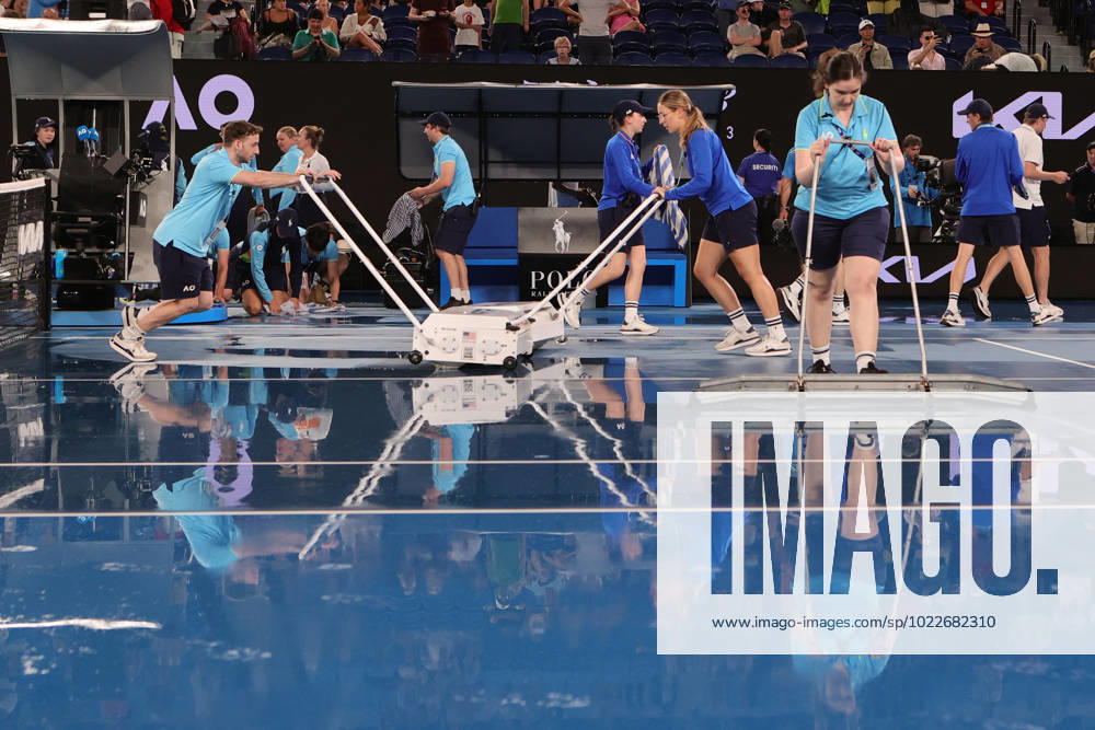 Rain delay as staff mop up the water before roof closure in the match between Elena Rybakina of Kazakistan and Jelena Ostapenko of Latvia during the Quarter Final, Day 9 at the Australian Open Tennis 2023 at Rod Laver Arena, Melbourne, Australia on 24 January 2023.