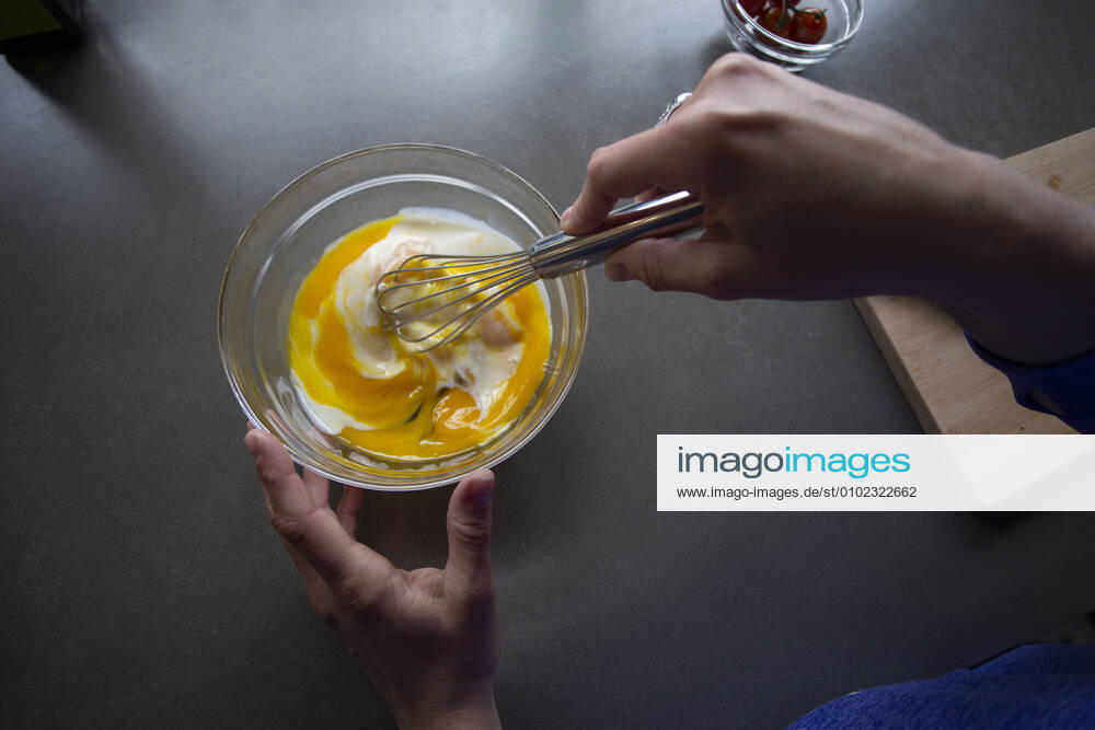 Overhead view of someone whisking milk into eggs in a bowl. Zeeland, NB, Netherlands CR_GAWA200701-425663-01