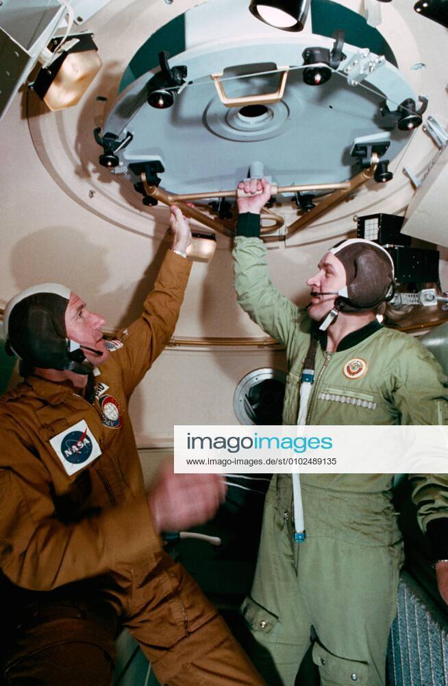 PICTURE SHOWS: (25 Feb. 1975) -- An interior view of the Soyuz orbital module mock-up in Building 35 during Apollo-Soyuz Test Project joint crew training at NASA s Johnson Space Center. The ASTP crewmen are astronaut Vance D. Brand (on left), command module pilot of the American ASTP prime crew; and cosmonaut Valeriy N. Kubasov, engineer on the Soviet ASTP first (prime) crew. The training session simulated activities on the second day in Earth orbit. ... STORY COPY: ANNIVERSARY (17 July 1975): Cold War Rivals Met in Space On July 17, 1975, something momentous happened: two Cold War-rivals met in space. When their respective spacecraft rendezvoused and docked, a new era of cooperative ventures in space began. For more than a decade, A