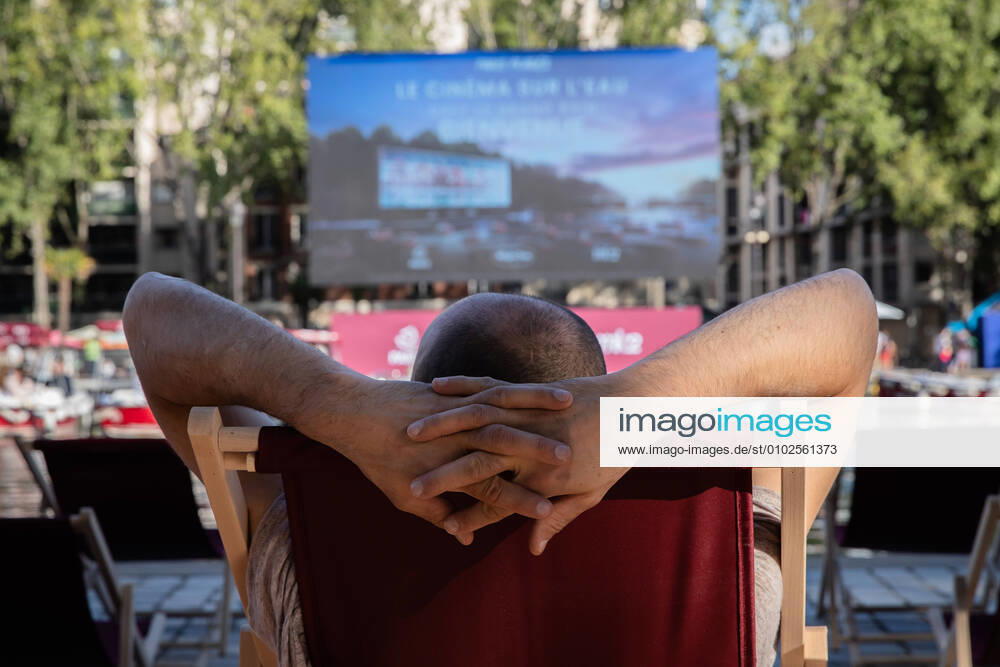 (200719) -- PARIS, July 19, 2020 (Xinhua) -- A man waits for the screening of the French movie Le Grand Bain in cinema on the water on the Bassin de la Villette, in Paris, Frence, July 18, 2020. The event cinema on the water was organized by Paris Plages (Paris Beaches). Thirty-eight small electric boats and a few deckchairs are installed along the Bassin de la Villette in front of the giant screen. (Photo by Aurelien Morissard Xinhua) FRANCE-PARIS-FLOATING CINEMA