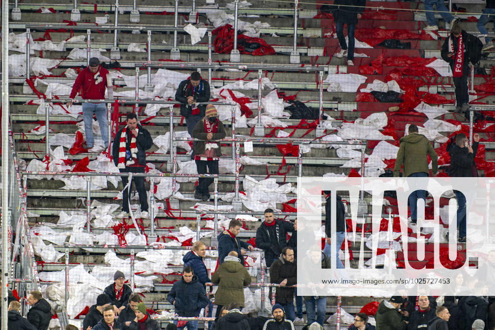 football UEFA Championsleague 2022 2023 round of 16 second leg, FC Bayern Munich Paris St Germain, at Allianz Arena Munich Bayernfans after the match amidst plastic residual waste of choreography