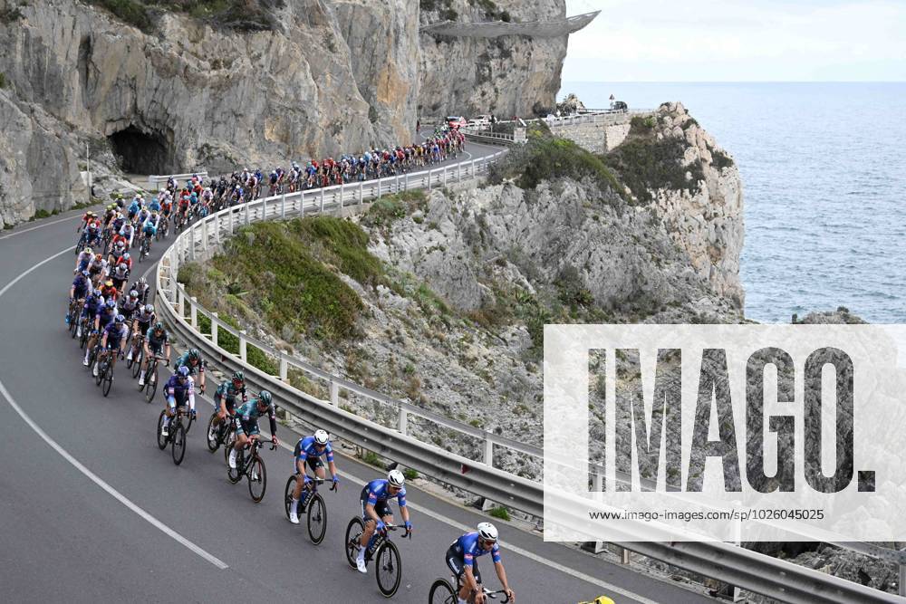 KW11 SANREMO, ITALY - MARCH 18 : Illustration picture of the peloton with riders of Alpecin-Deceuninck riding by the Italian Riviera of Flowers during the UCI WorldTour 114th Milan - Sanremo cycling race with start in Abbiategrasso and finish at the Via Roma in Sanremo on March 18, 2023 in Sanremo, Italy, 18 03 2023 ( Motordriver Kim Tiebergyn - 2023 Milan - Sanremo UCI WorldTour cycling race PhotoNews Panoramic