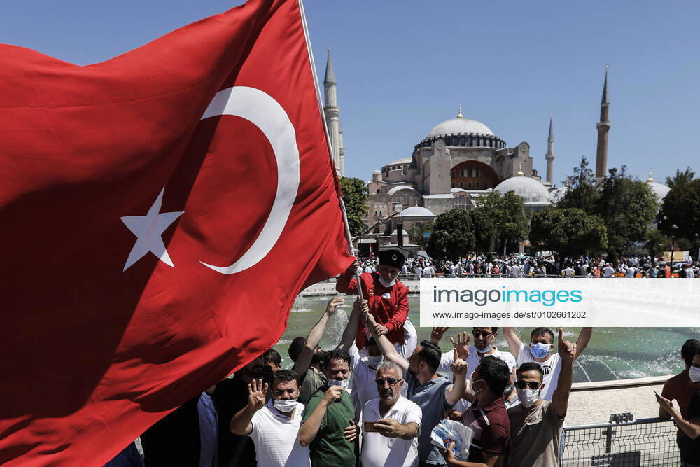 People hold Turkish flag and celebrating Hagia SophiaÃ¢â‚¬â ¢s reconversion at outside of the Hagia Sophia Mosque. Istanbul Turkey - ZUMAz112 20200724_zip_z112_056