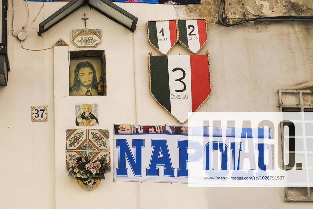 The inscription Napoli and an effigy of the scudetto (the symbol with the colors of the Italian flag that is affixed to the jersey of the team that wins the Italian Serie A soccer championship) are displayed in downtown next to a votive altar. Preparations are in full swing in the city to celebrate the final victory of SSC Napoli, which leads the Italian championship with a 19-point lead with 11 games to go ABPH7124