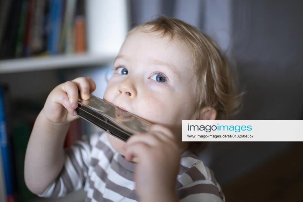 Toddler plays on a harmonica Bonn Germany