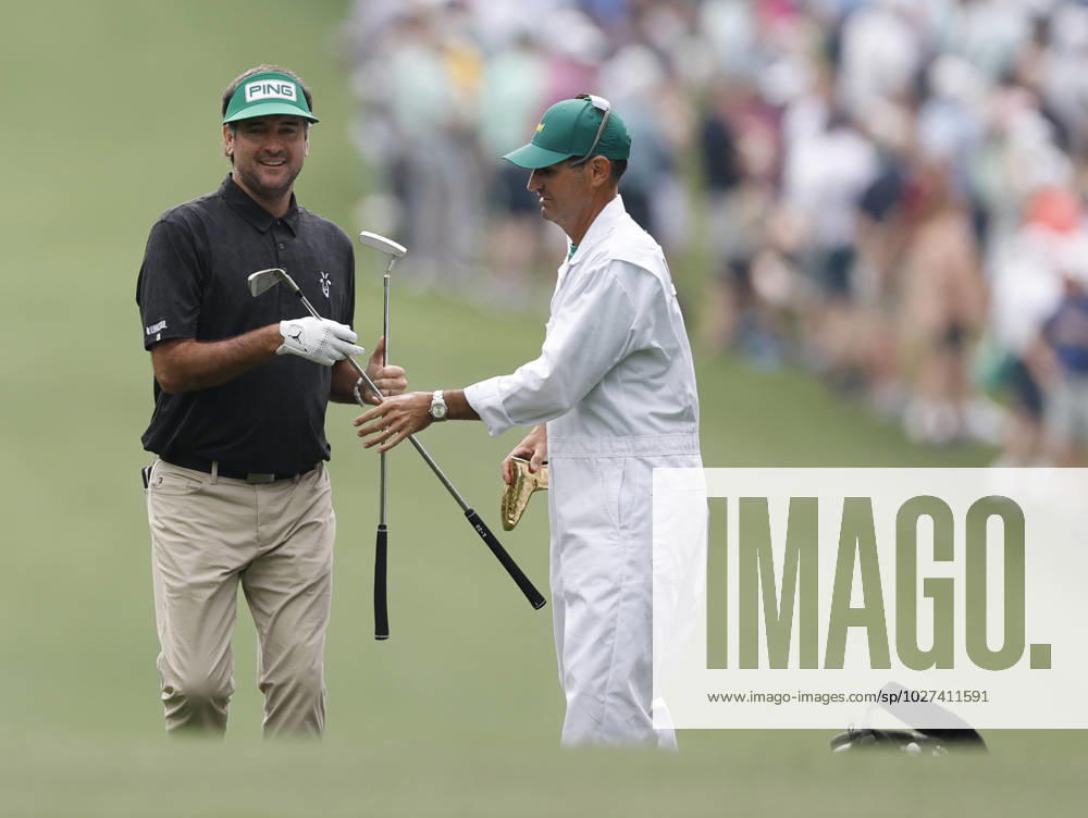 Bubba Watson receives his putter from caddie Brandon Parsons after approach shot on the first hole during the first round at the Masters tournament at Augusta National Golf Club in Augusta, Georgia on Thursday, April 6, 2023. AUG20230406253 JOHNxANGELILLO