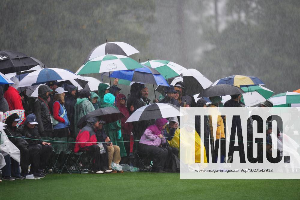 (230409) -- AUGUSTA, April 9, 2023 -- Audience watch the match in the rain during the second round of the 2023 Masters golf tournament at Augusta National Golf Club in Augusta, the United States, on April 8, 2023. ) (SP)U.S.-AUGUSTA-MASTERS-GOLF TOURNAMENT WuxXiaoling