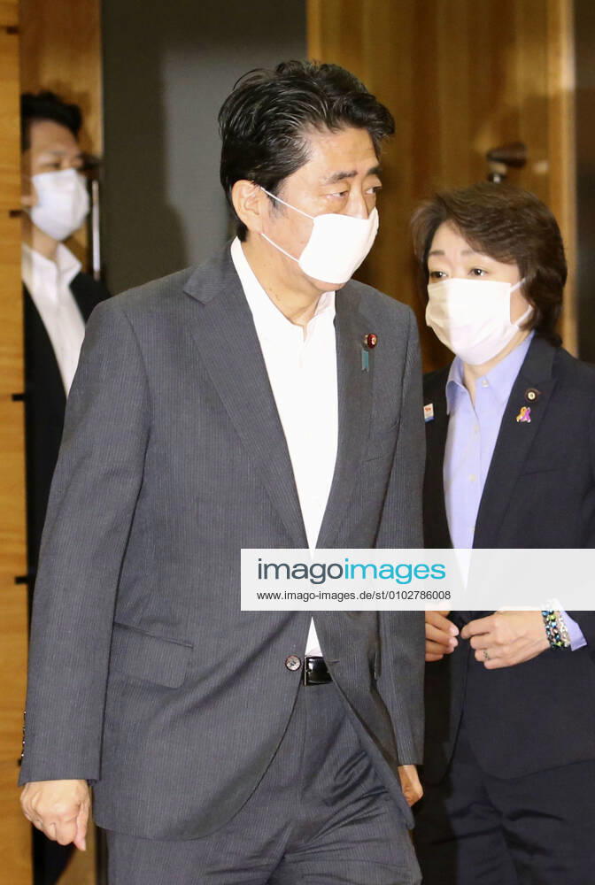 Japan PM Abe Japanese Prime Minister Shinzo Abe is pictured ahead of a Cabinet meeting at his office in Tokyo on July 31, 2020. Seen on the right is Olympic minister Seiko Hashimoto.