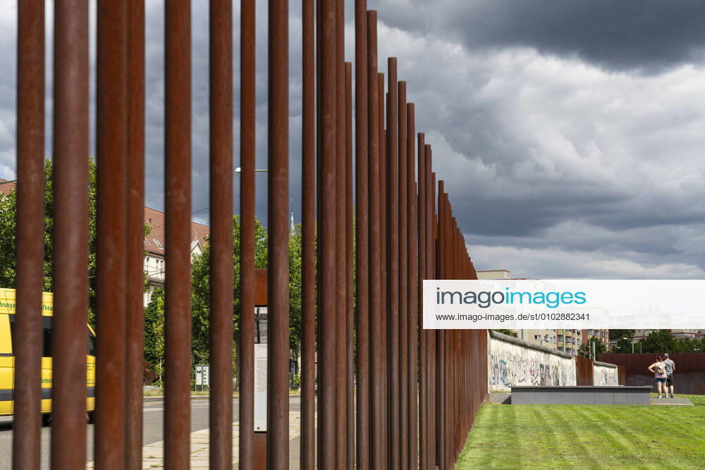 Tourists at the Berlin Wall Memorial on Bernauer Strasse in Berlin Prenzlauer Berg Rusty iron pipes mark the course of the border between East and West Berlin Photo Volker Hohlfeld Berlin Wall Memorial