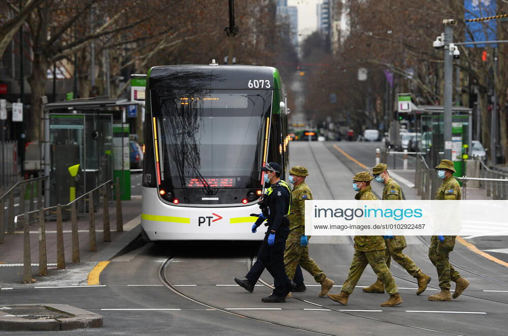VICTORIA CORONAVIRUS COVID-19, Victorian Police officers and ADF personnel are seen along Bourke street in Melbourne, Friday, August 7, 2020. Stage four coronavirus restrictions are in force across metropolitan Melbourne including a 8pm to 5am curfew, people must remain within a 5km radius of their homes and an hourly limit on exercise has been introduced. ( NO ARCHIVING, , NO USE IN BOOKS WITHOUT CONSENT MELBOURNE VICTORIA AUSTRALIA