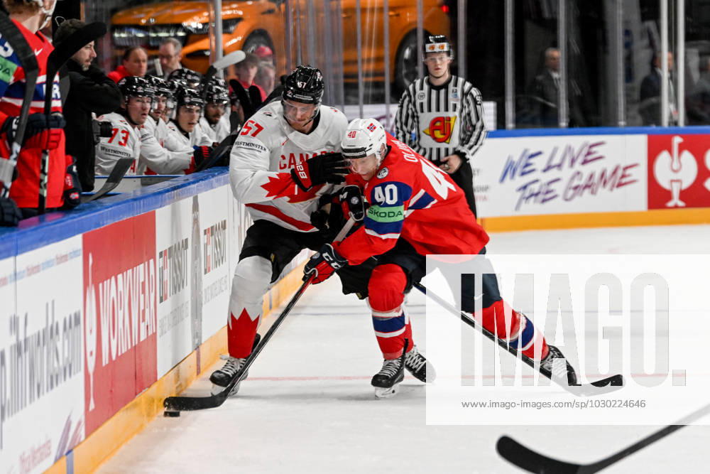 RIGA, LATVIA MAY 22 Tyler Myers of Canada and Ken Andre Olimb of Norway battle for the puck along the boards during the 2023 IIHF Ice Hockey World Championship Finland Latvia game between Canada and Norway at Arena Riga on May 22, 2023 in Riga, Latvia Riga Arena Riga Latvia