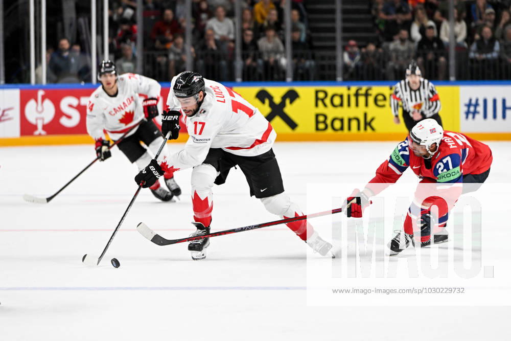RIGA, LATVIA MAY 22 Milan Lucic of Canada defends the puck against Andreas Martinsen of Norway during the 2023 IIHF Ice Hockey World Championship Finland Latvia game between Canada and Norway at Arena Riga on May 22, 2023 in Riga, Latvia Riga Arena Riga Latvia