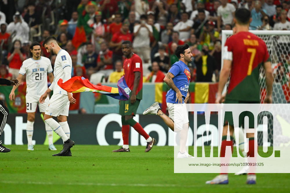 World Cup - A man with an LGBT flag during Portugal - Uruguay - Qatar A man carrying a rainbow flag and wearing a T-shirt in support of Iranian women ran into the pitch during Portugal v Uruguay match of the FIFA World Cup, WM, Weltmeisterschaft, Fussball Qatar 2022 Al Lusail Stadium in Doha, Qatar on November 28, 2022. Photo by Laurent Zabulon ABACAPRESS.COM Doha Qatar