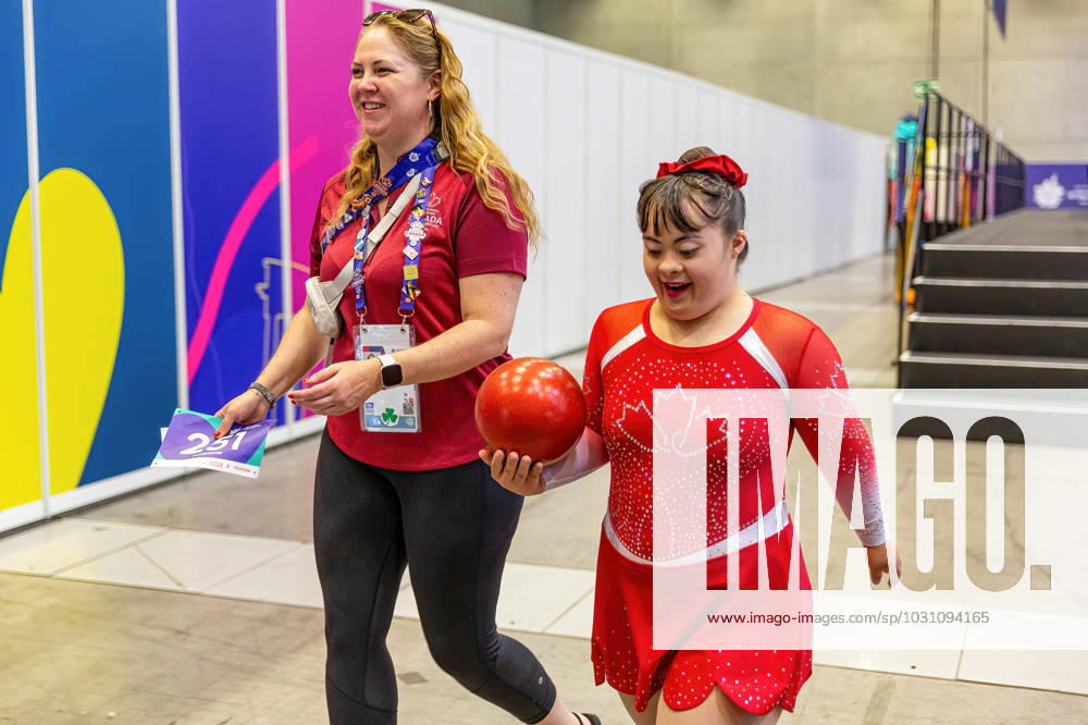 An athlete from Canada walks with her coach after competition in Rhythmic gymnastics, Rhythmische Sportgymnastik, RSG discipline during the Special Olympics Summer World Games Berlin 2023 in Messe conference centre. The 2023 Berlin Games will host 7000 athletes with learning disabilities from 190 countries. Special Olympics is an international charity which aims to include individuals with learning disabilities into the realm of olympic sports. Berlin 2023 is the biggest sporting as well as charitable event of 2023. Berlin Germany - ZUMAs197 20230618_zaa_s197_128