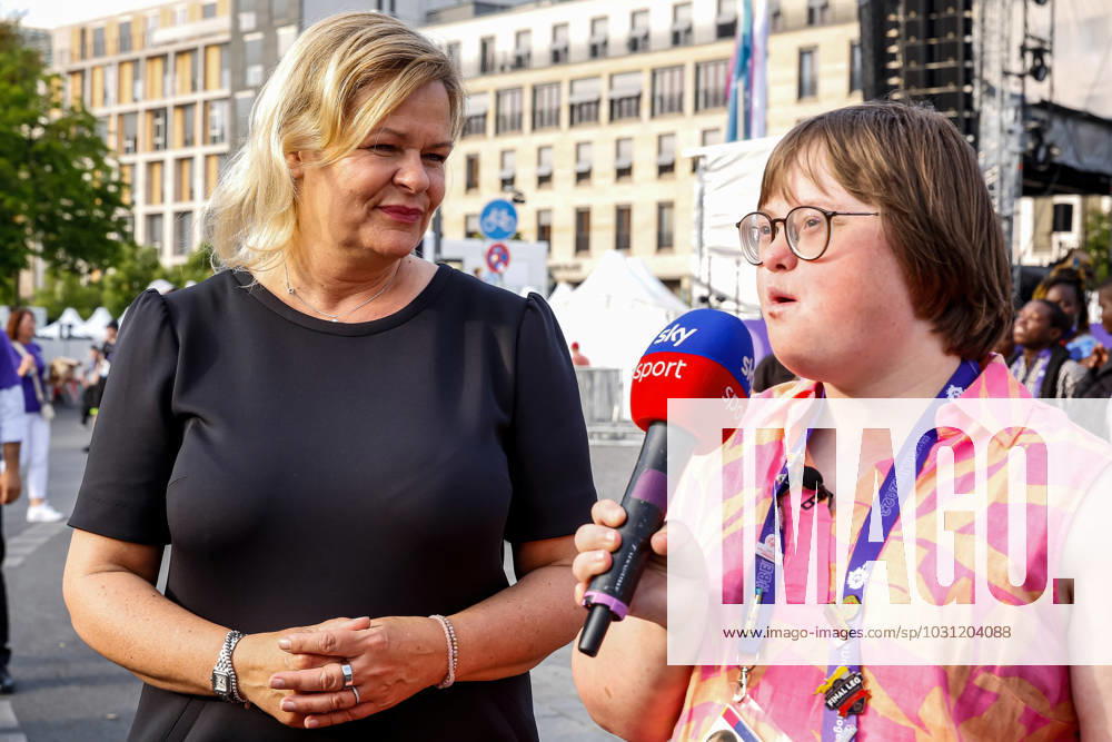 Special Olympics volunteer journalist with down syndrome interviews Germany Interior Minister Nancy Faeser for Sky during the street party for athletes and supporters of the Special Olympics. Summer World Games Berlin 2023 in front of the Brandenburg Gate in the center of Berlin. The 2023 Berlin Games hosts 7000 athletes with learning disabilities from nearly 190 countries. Special Olympics is an international charity which aims to include individuals with learning disabilities into the realm of Olympic sports. Berlin 2023 is the biggest sporting and charitable event of 2023. Berlin Germany - ZUMAs197 20230622_zaa_s197_564