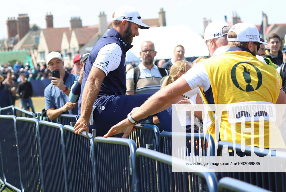 American Dustin Johnson climbs over the railings after a mishit from the 1st tee on the first day at the 151st Open Championship at Royal Liverpool Golf Club in Hoylake, England on Thursday, July 20, 2023. LON2023072041 HUGOxPHILPOTT