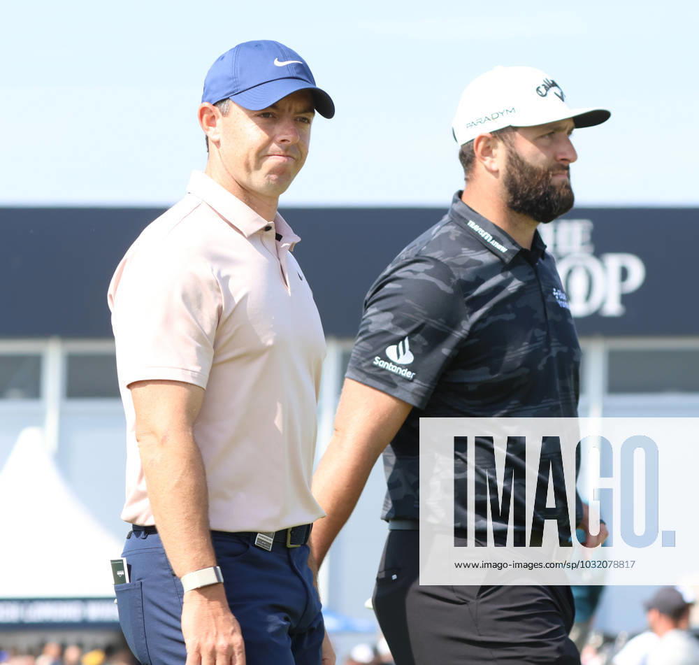 Northern Ireland s Rory Mcllroy smiles with Jon Rahm as he walks on the fourth fairway on the first day at the 151st Open Championship at Royal Liverpool Golf Club in Hoylake, England on Thursday, July 20, 2023. LON20230720118 HUGOxPHILPOTT