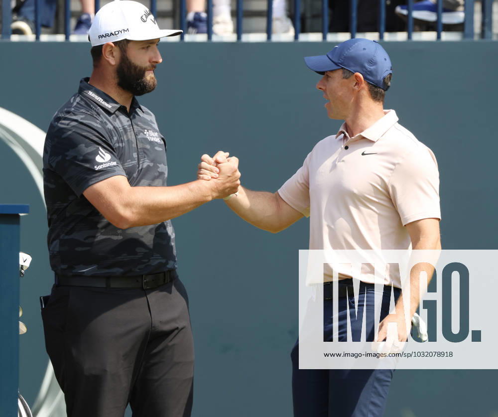 Northern Ireland s Rory Mcllroy shakes Spain s Jon Rahm s hand on the 1st tee on the first day at the 151st Open Championship at Royal Liverpool Golf Club in Hoylake, England on Thursday, July 20, 2023. LON2023072083f HUGOxPHILPOTT
