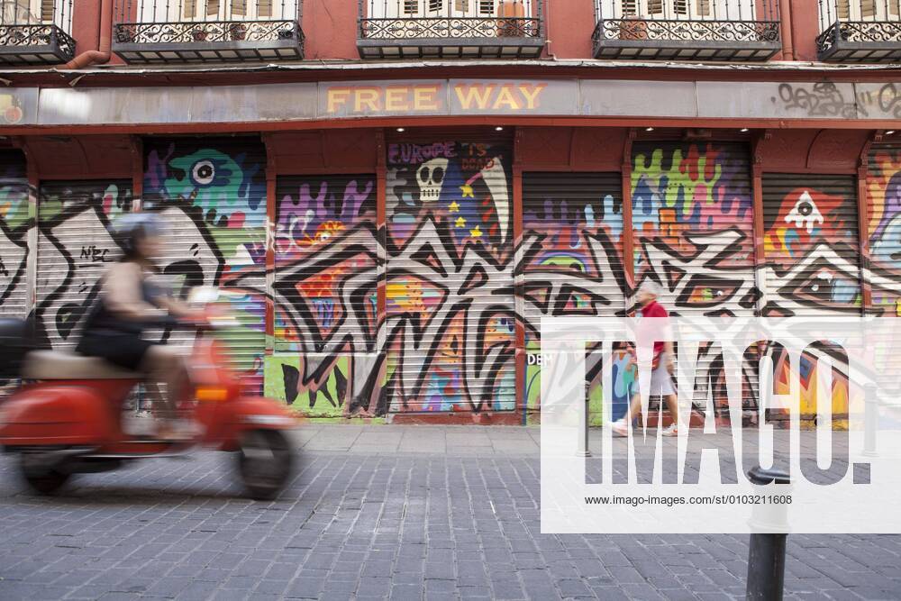 Row of shops with graffiti in the Malasana district, Madrid, Spain, Europe