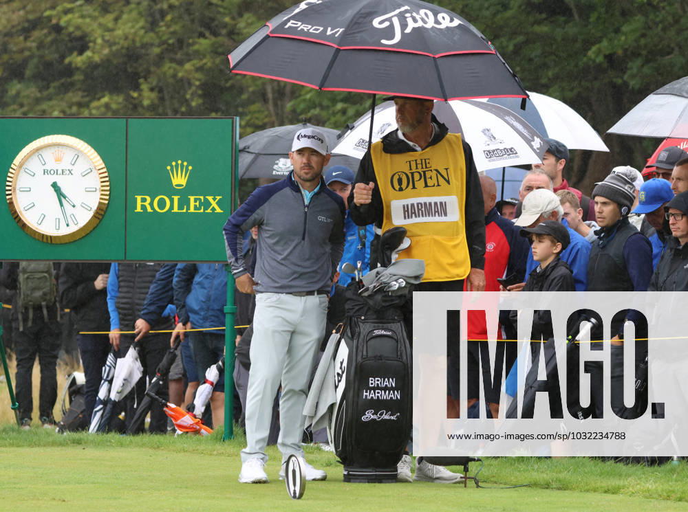 American Brian Harman shelters under an umbrella on the fifth tee on the third day at the 151st Open Championship at Royal Liverpool Golf Club in Hoylake, England on Saturday, July 22, 2023. LON2023072231 HUGOxPHILPOTT