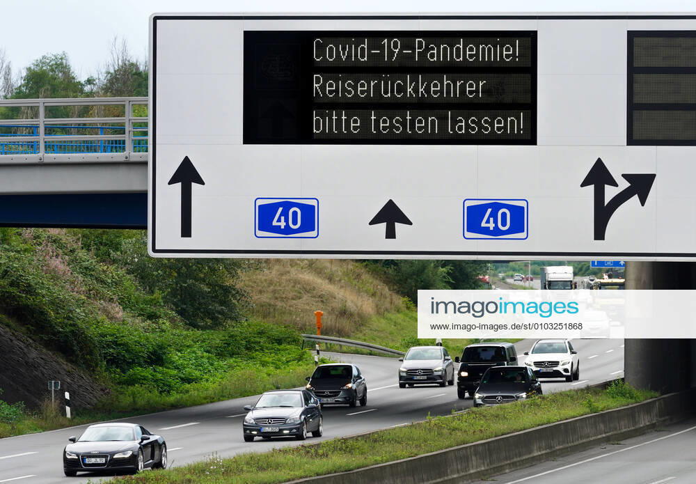 Invitation to travel returnees to have themselves tested for the corona virus due to the Covid 19 pandemic Sign gantry on the A40 motorway in the Dortmund area