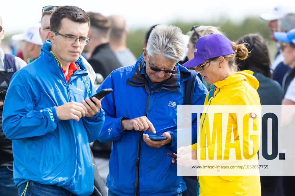 29th July 2023; Royal Porthcawl, Porthcawl, Bridgend, Wales: Senior Open Championship, Round 3; Spectators check their apps on their phones for the tee off list. ActionPlus12536830 DanxMinto