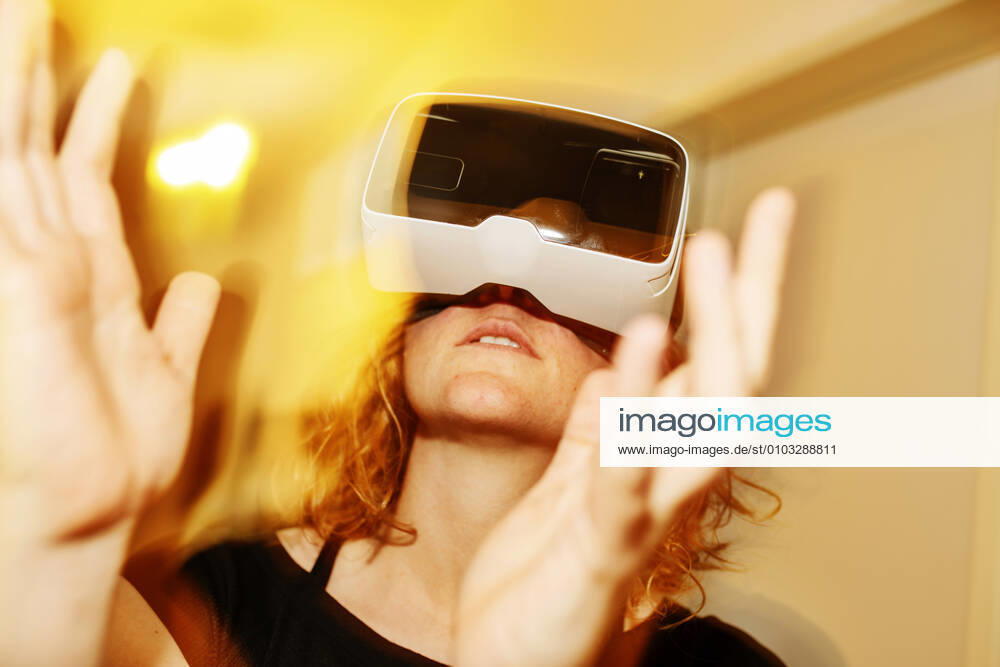 Close-up of woman looking through virtual reality simulator at home model released Symbolfoto property released JATF01216