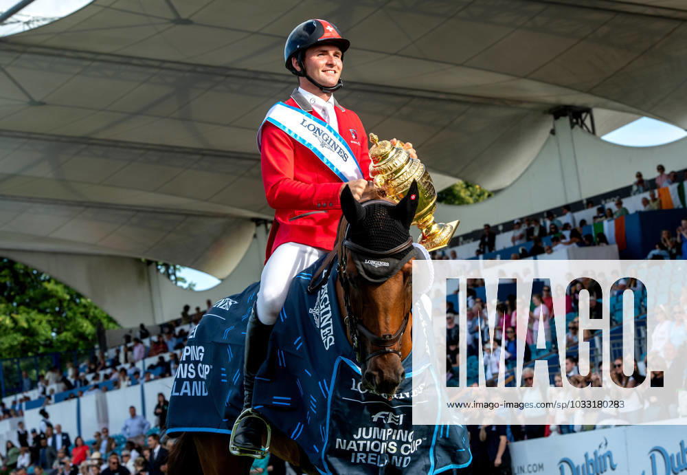 BRYAN BALSIGER of Switzerland rides with the trophy on CHELSEA Z after the team win in the Longines FEI Jumping Nations Cup of Ireland in Dublin, Ireland, Aug 11, 2023. Dublin Ireland